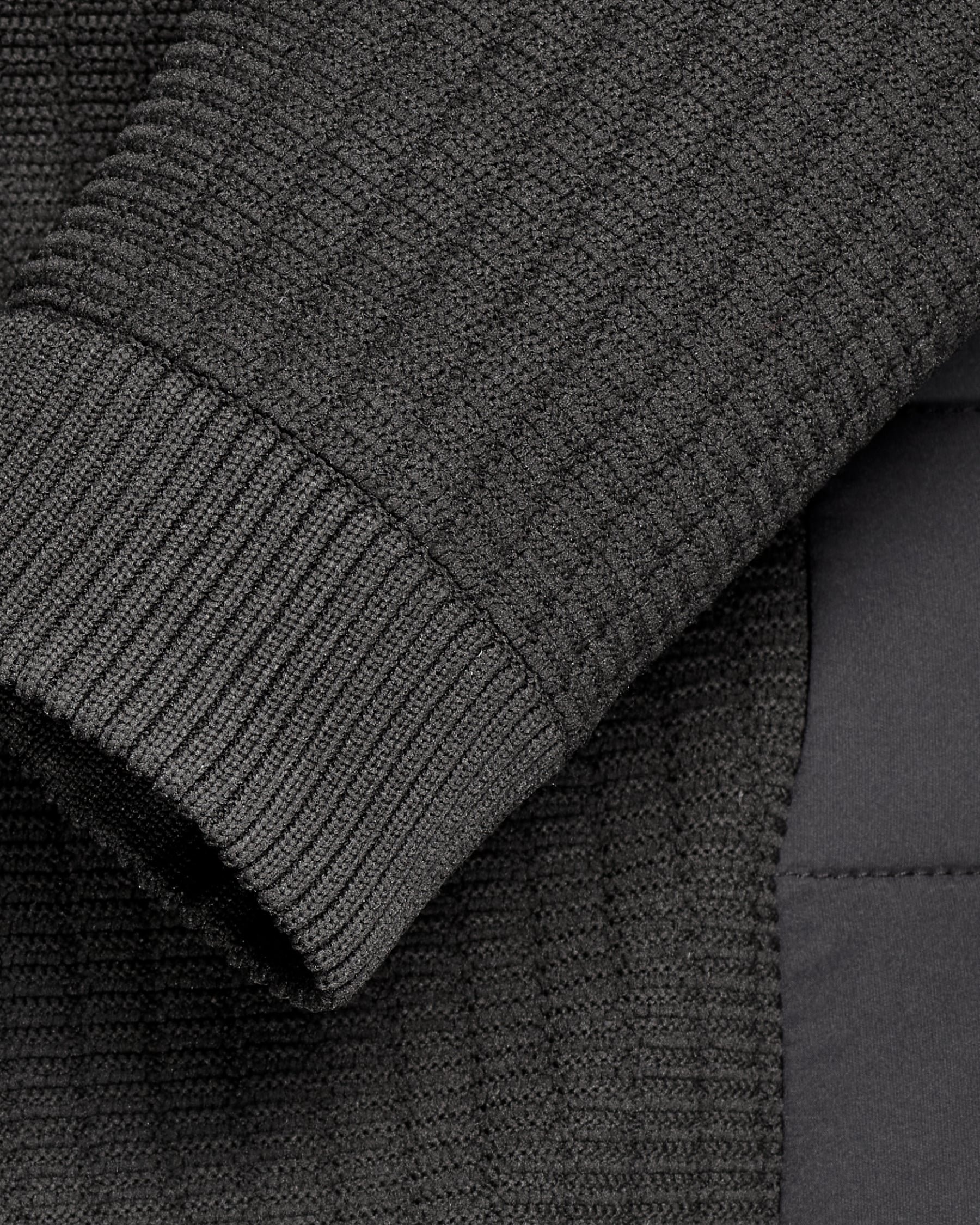 Close-up of zipper and pocket details on STRAUSS e.s.trail pure hybrid jacket in black