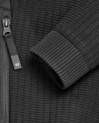 Close-up of zipper and pocket details on STRAUSS women's e.s.trail pure hybrid jacket in black
