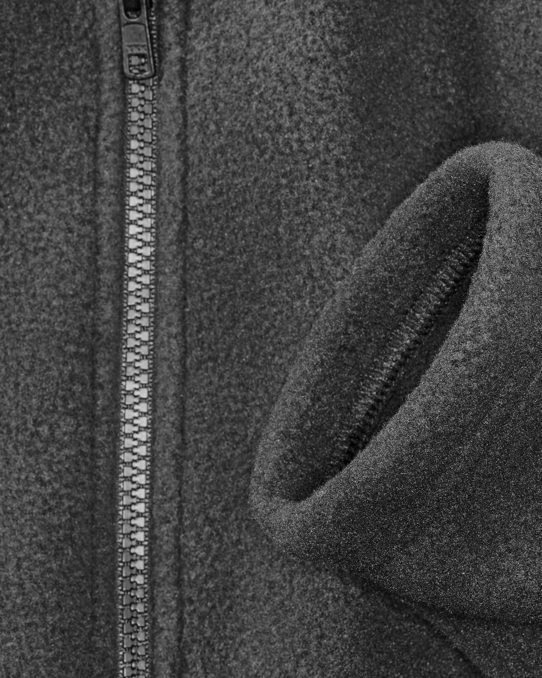 Close-up of pocket and collar details on STRAUSS full-zip fleece jacket in black