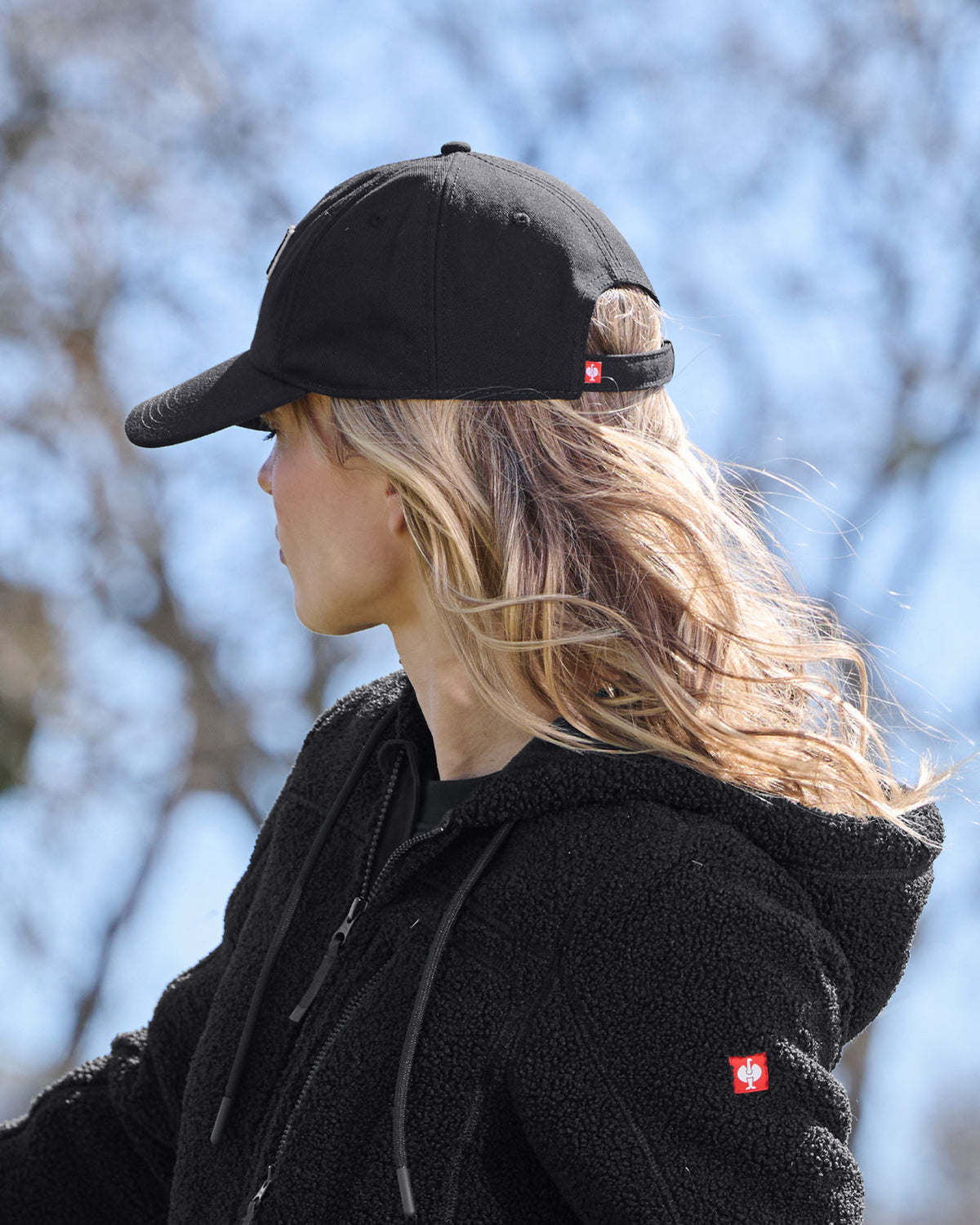 A model wears a black STRAUSS e.s.e:pic cap with a casual STRAUSS workwear outfit.