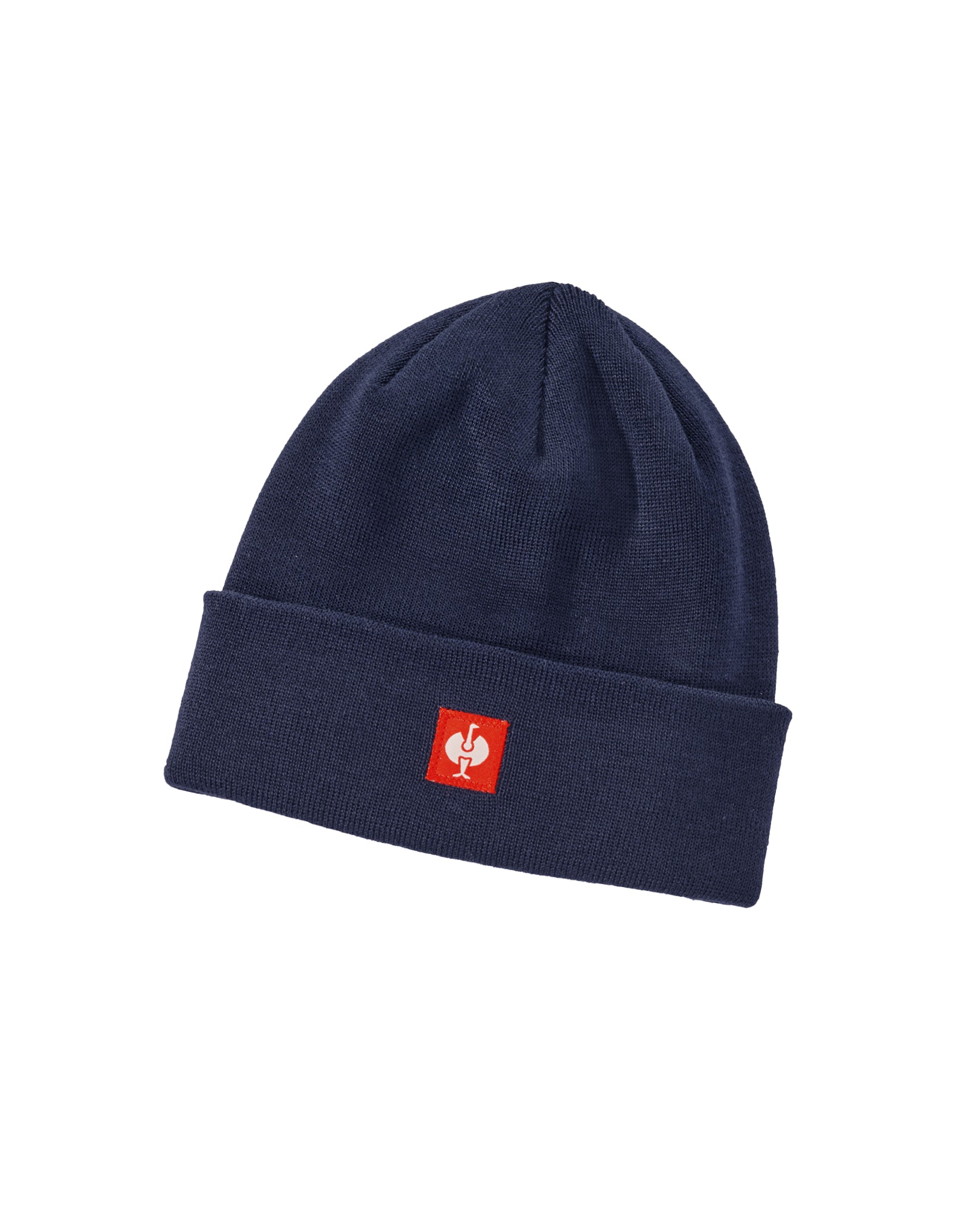 A navy blue knit beanie hat with a folded cuff, featuring a small red square patch on the front with a white stylized logo.