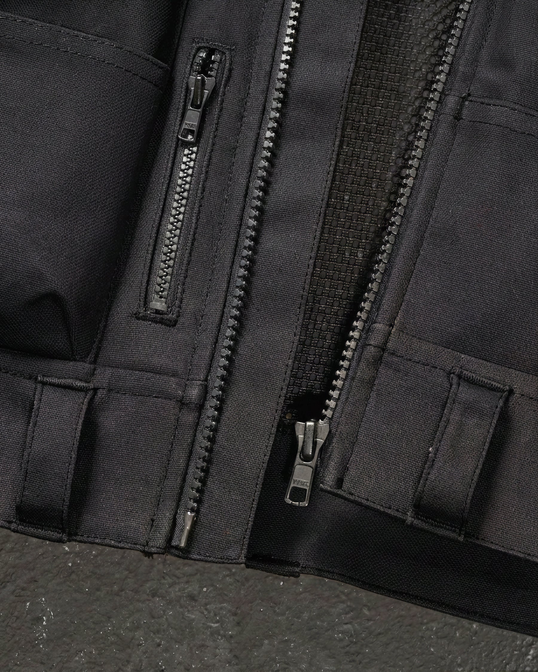 Close-up of tool pockets and storage details on STRAUSS e.s.iconic tool vest in black