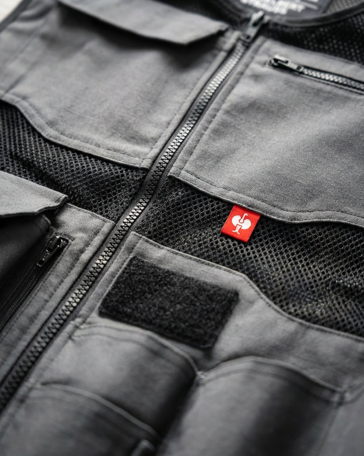 Close-up of reinforced pocket and closure details on STRAUSS e.s.iconic tool vest in carbon gray and black