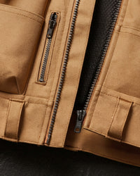 Close-up of tool pockets and storage details on STRAUSS e.s.iconic tool vest in almond brown and black