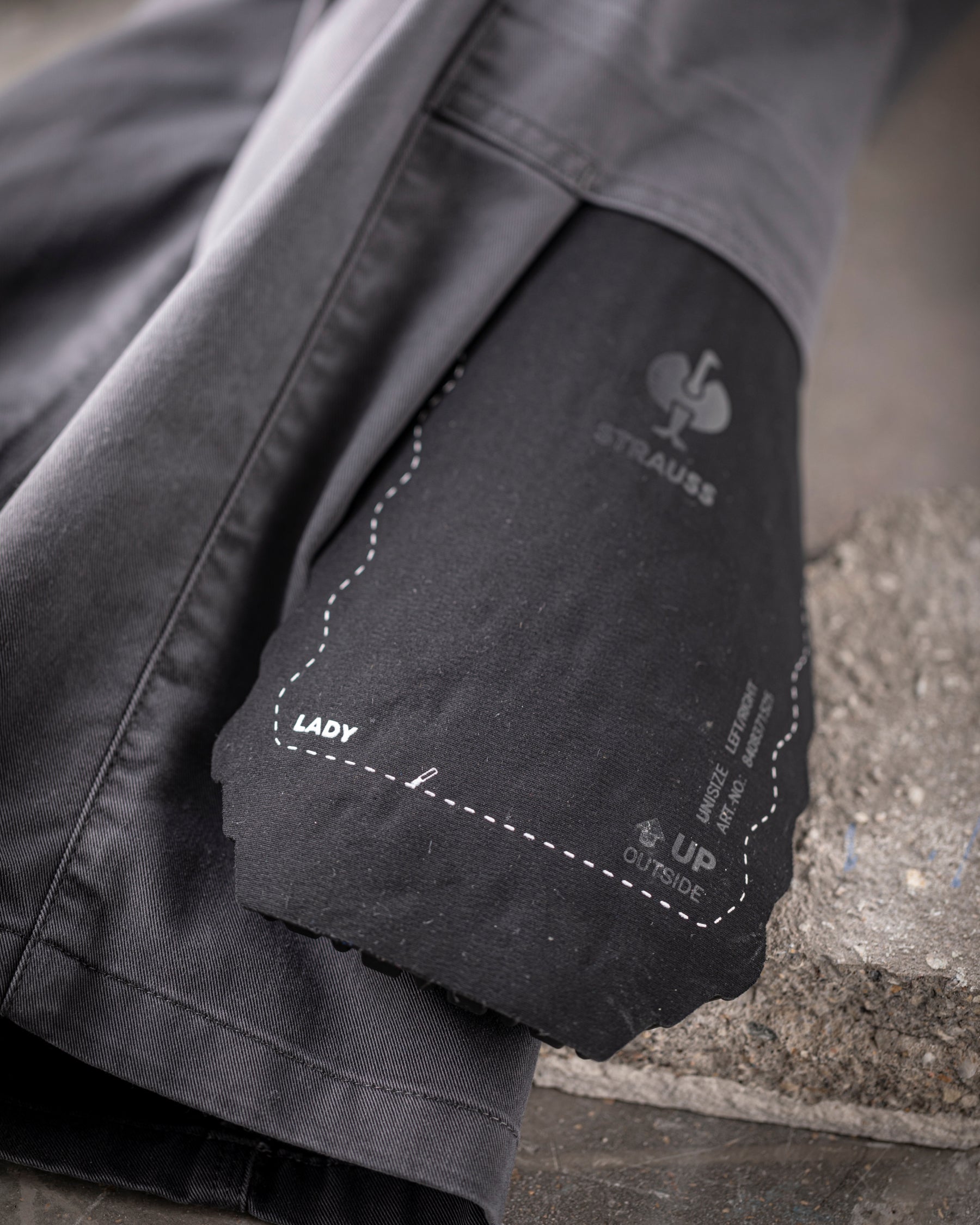 Close-up of the surface texture and ergonomic profile on the graphite STRAUSS comfort cell knee pads.