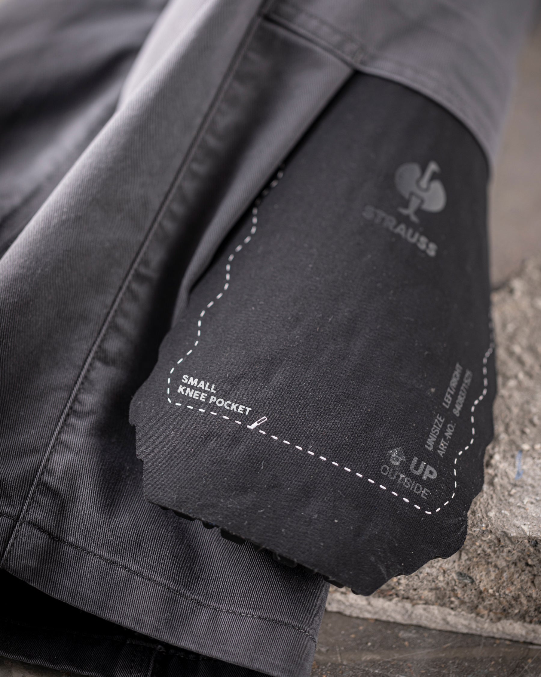 Close-up of the surface texture and ergonomic profile on the graphite STRAUSS comfort cell knee pads.