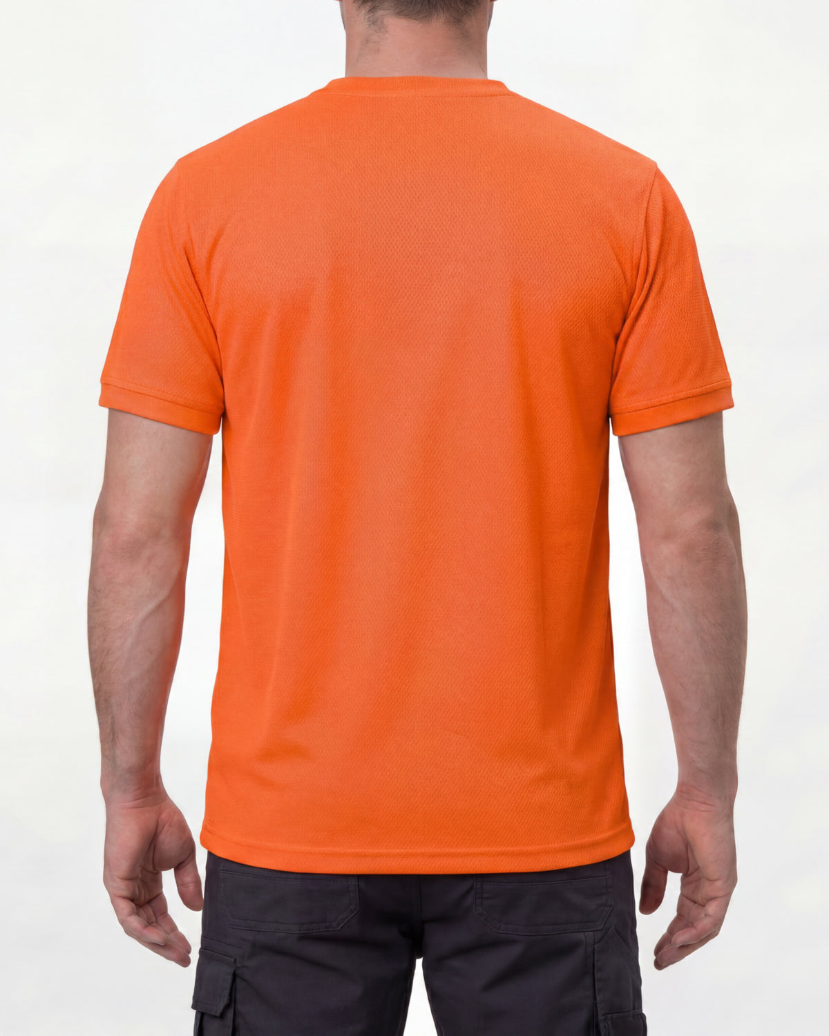 A model wears the STRAUSS Enhanced Visibility Performance T-Shirt in neon orange with dark work pants and work boots, showing the shirt fit