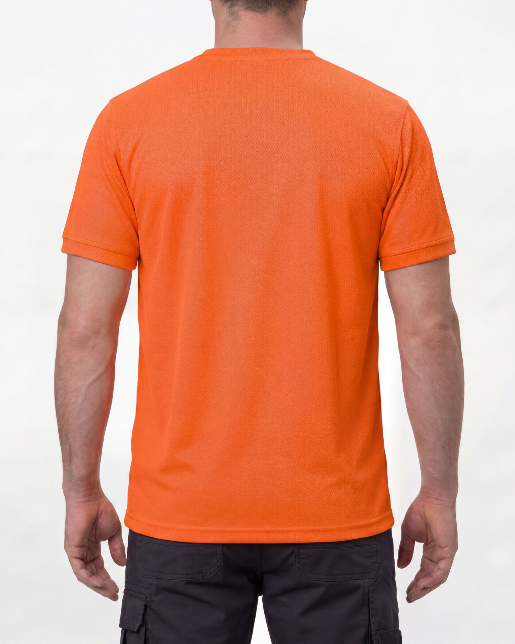 A model wears the STRAUSS Enhanced Visibility Performance T-Shirt in neon orange with dark work pants and work boots, showing the shirt fit