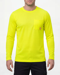 A model wears the STRAUSS Enhanced Visibility Performance Long Sleeve Shirt in neon yellow with dark work pants and work boots in a studio product scene