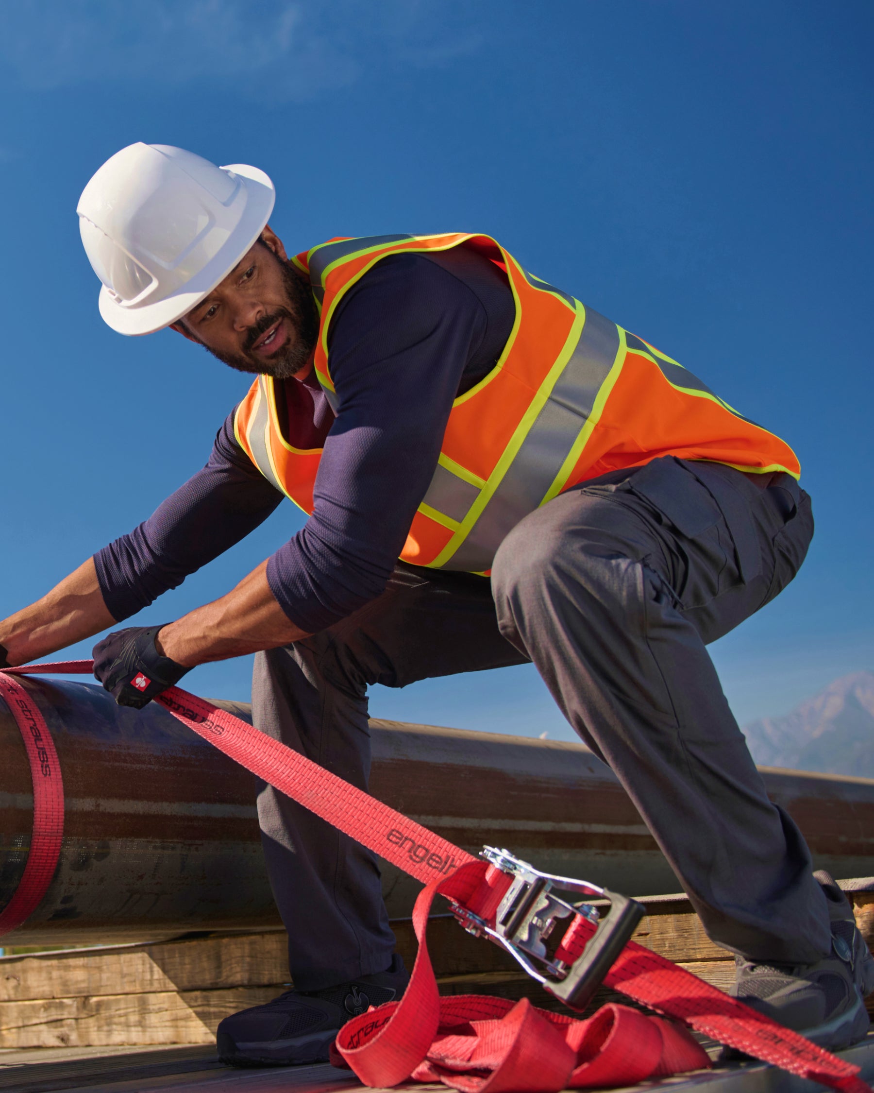 STRAUSS high visibility vest in neon orange in use with workwear