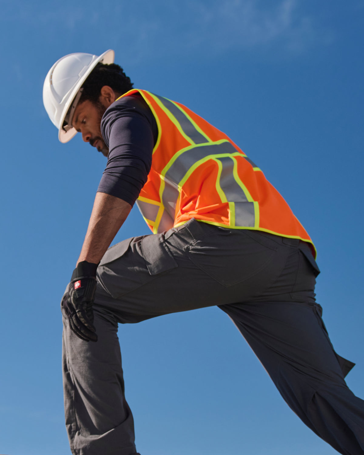 STRAUSS high visibility vest in neon orange paired with work pants