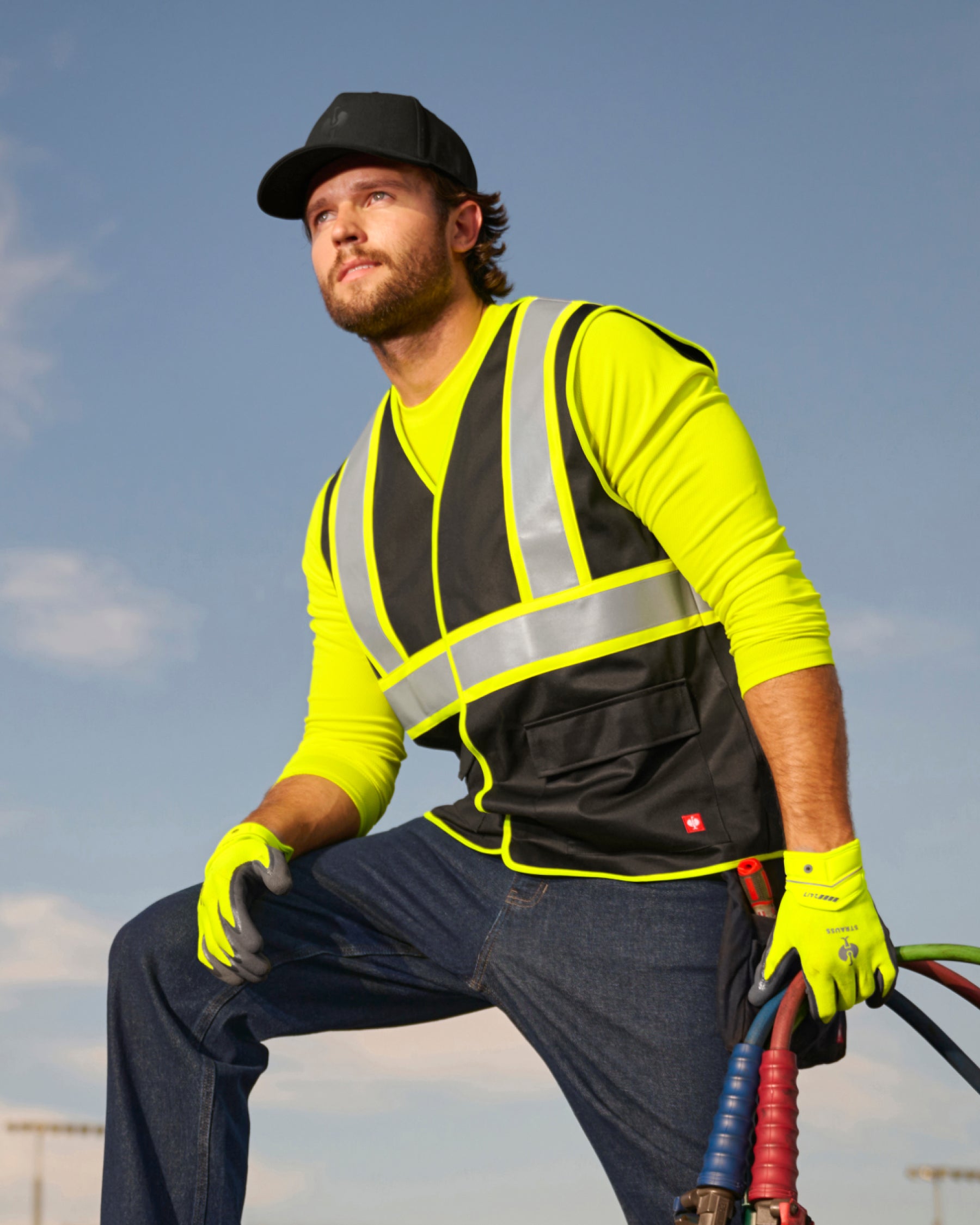 STRAUSS enhanced visibility vest in black worn for high-visibility work