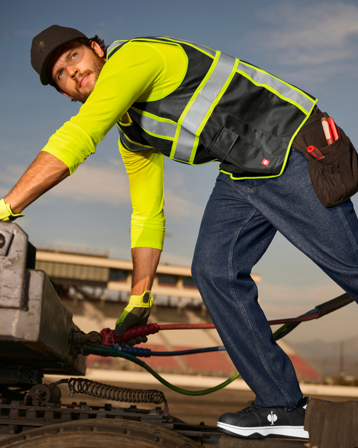 STRAUSS enhanced visibility vest in black in use with workwear