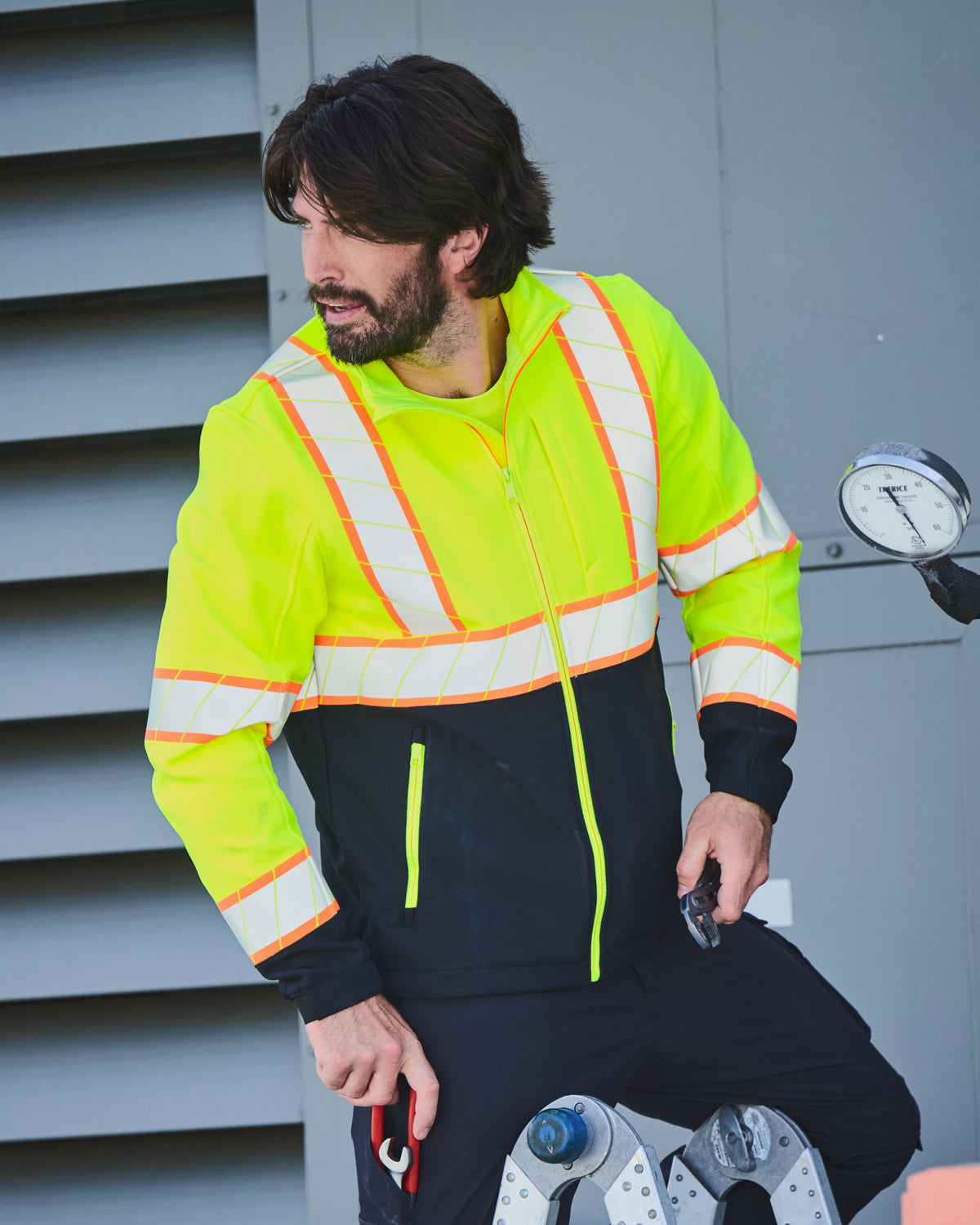 STRAUSS Class 2 high visibility softshell jacket in neon yellow and black paired with work pants
