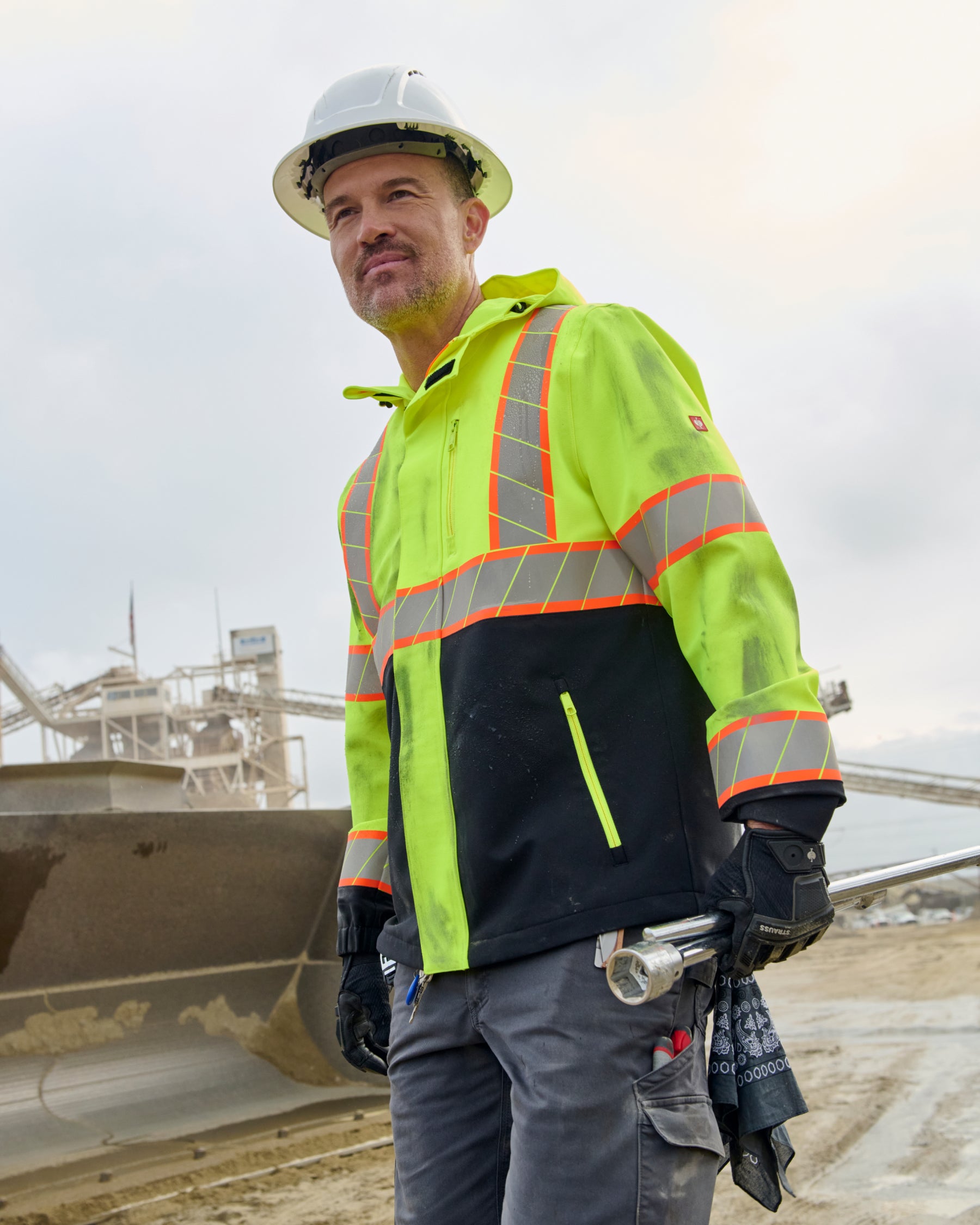 STRAUSS Class 2 high visibility waterproof jacket in neon yellow and black in use with workwear