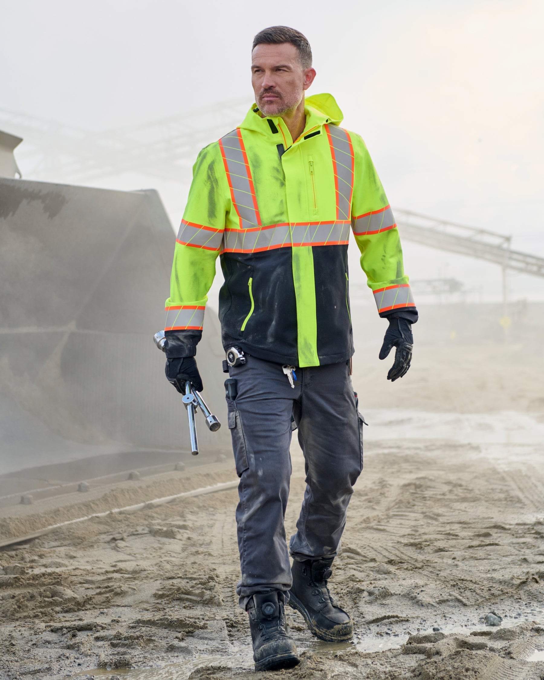 STRAUSS Class 2 high visibility waterproof jacket in neon yellow and black paired with work pants
