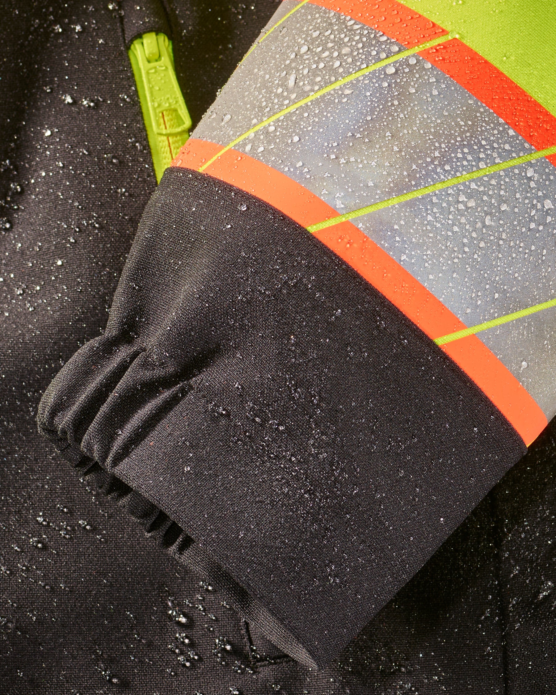 Close-up of zipper and pocket details on STRAUSS Class 2 high visibility waterproof jacket in neon yellow and black