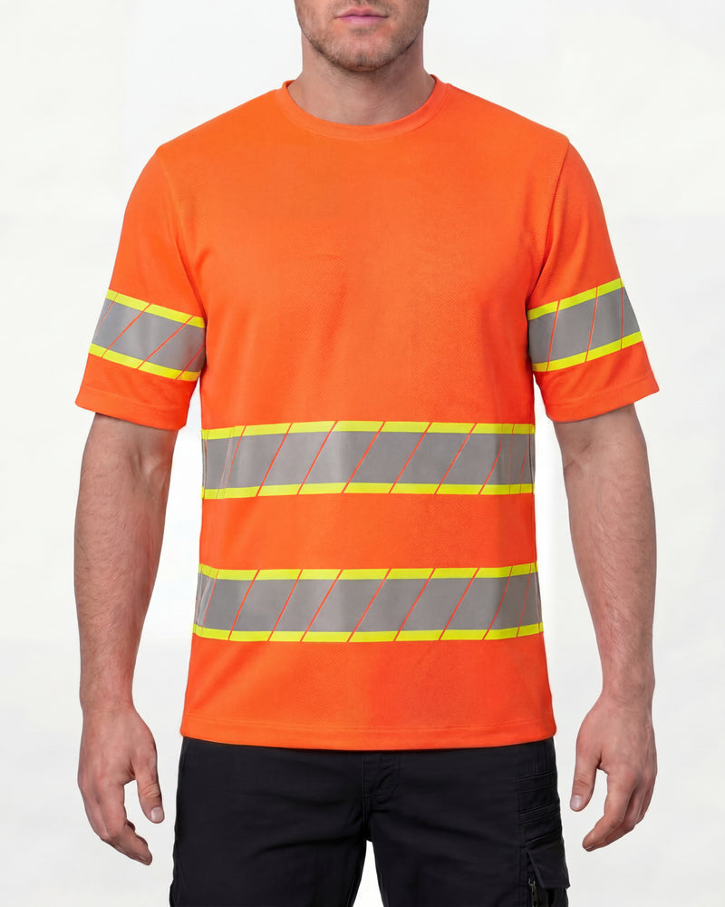 A model wears the STRAUSS Class 2 High Visibility T-Shirt in neon orange with dark work pants and work boots in a studio product scene