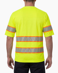 A model wears the STRAUSS Class 2 High Visibility T-Shirt in neon yellow with dark work pants and work boots, showing the shirt fit