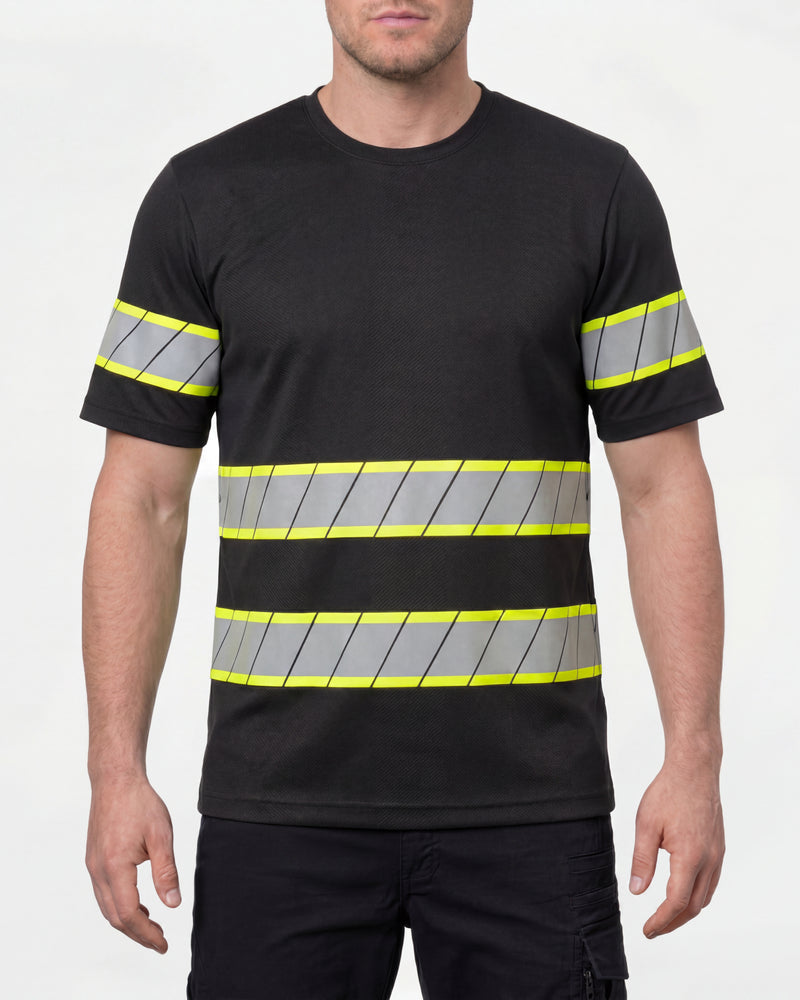 A model wears the STRAUSS Enhanced Visibility T-Shirt in black with dark work pants and work boots in a studio product scene