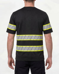 A model wears the STRAUSS Enhanced Visibility T-Shirt in black with dark work pants and work boots, showing the shirt fit