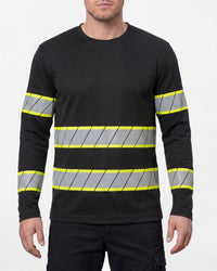 A model wears the STRAUSS Enhanced Visibility Long Sleeve Shirt in black with dark work pants and work boots in a studio product scene