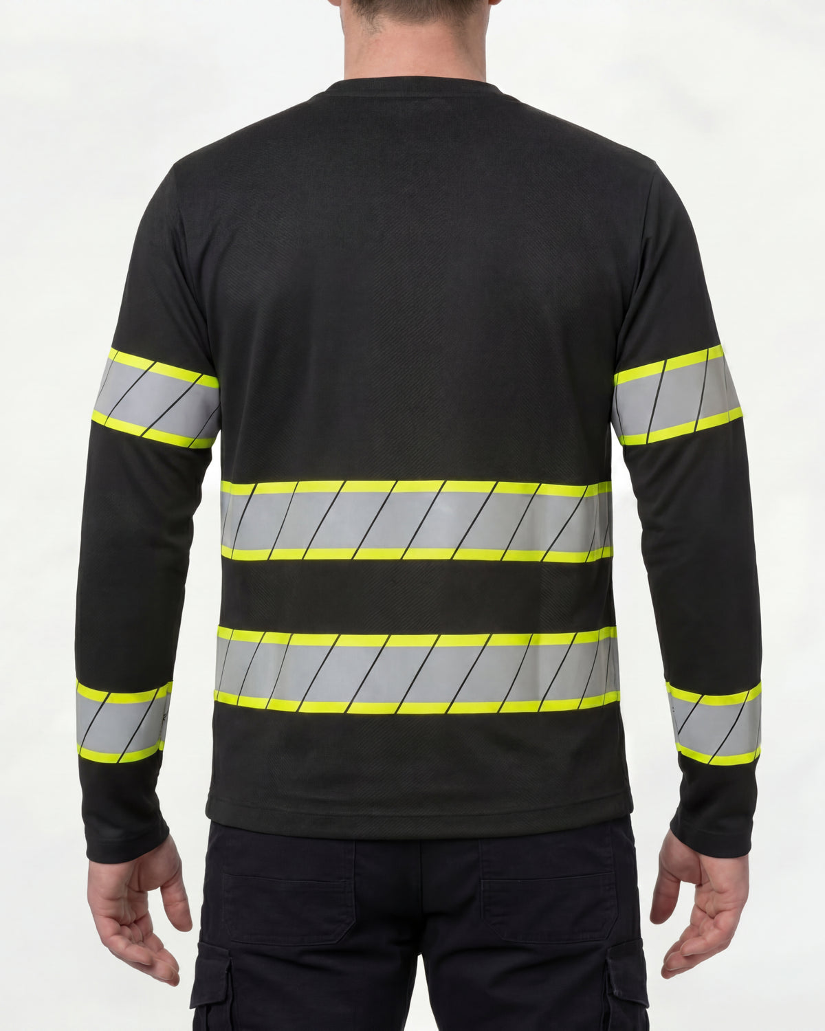 A model wears the STRAUSS Enhanced Visibility Long Sleeve Shirt in black with dark work pants and work boots, showing the shirt fit