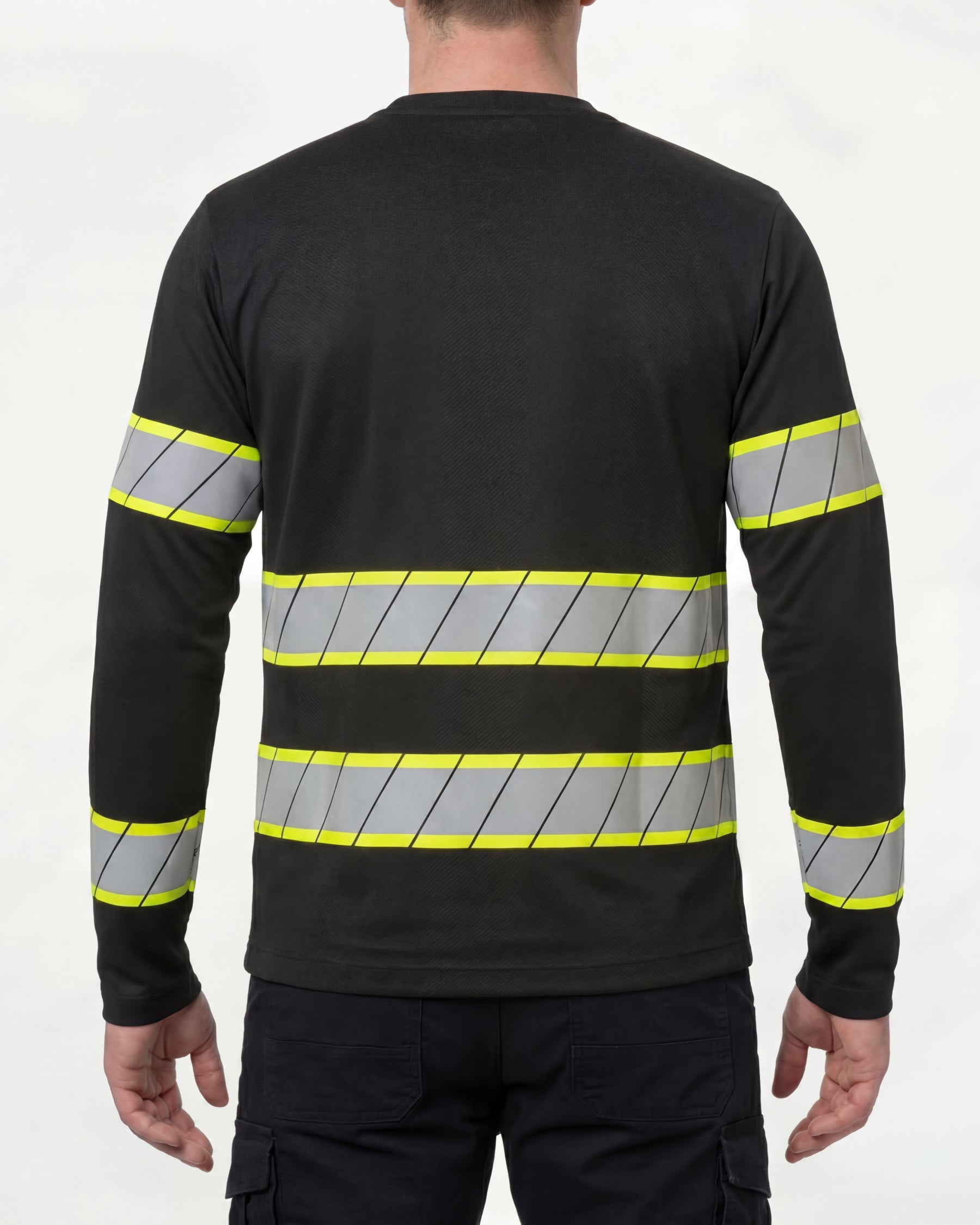 A model wears the STRAUSS Enhanced Visibility Long Sleeve Shirt in black with dark work pants and work boots, showing the shirt fit