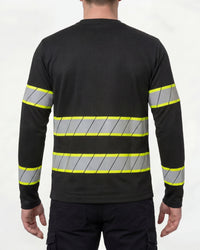 A model wears the STRAUSS Enhanced Visibility Long Sleeve Shirt in black with dark work pants and work boots, showing the shirt fit