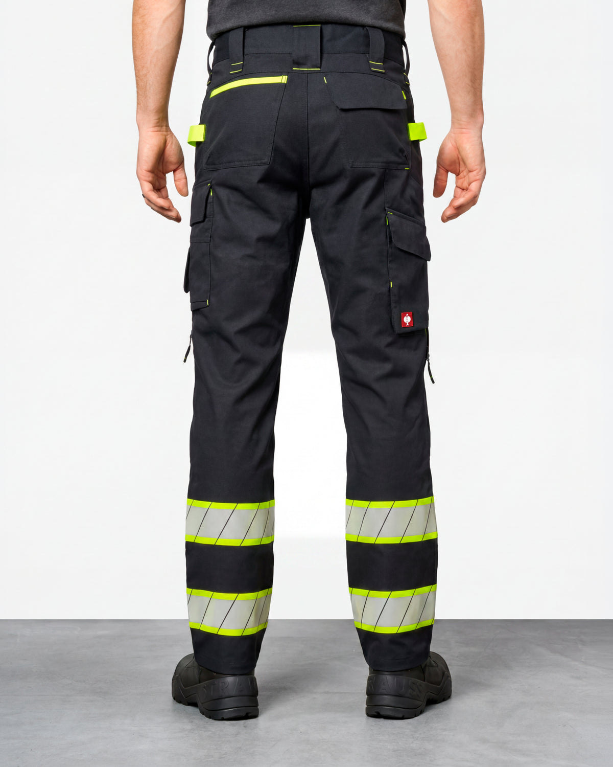 Enhanced Visibility Work Pants in black worn by a model, rear view
