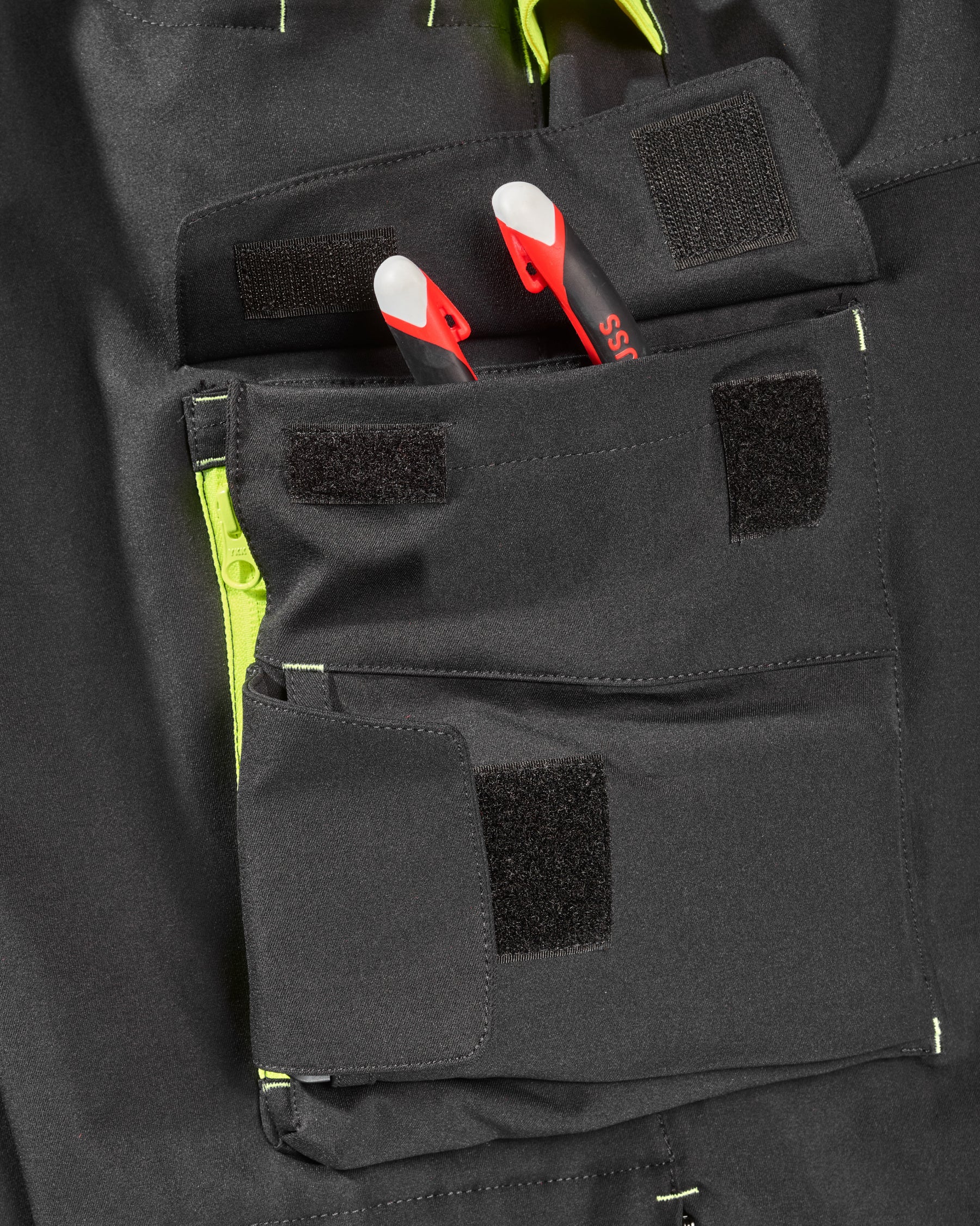 Close-up of reflective workwear details on Enhanced Visibility Work Pants in black