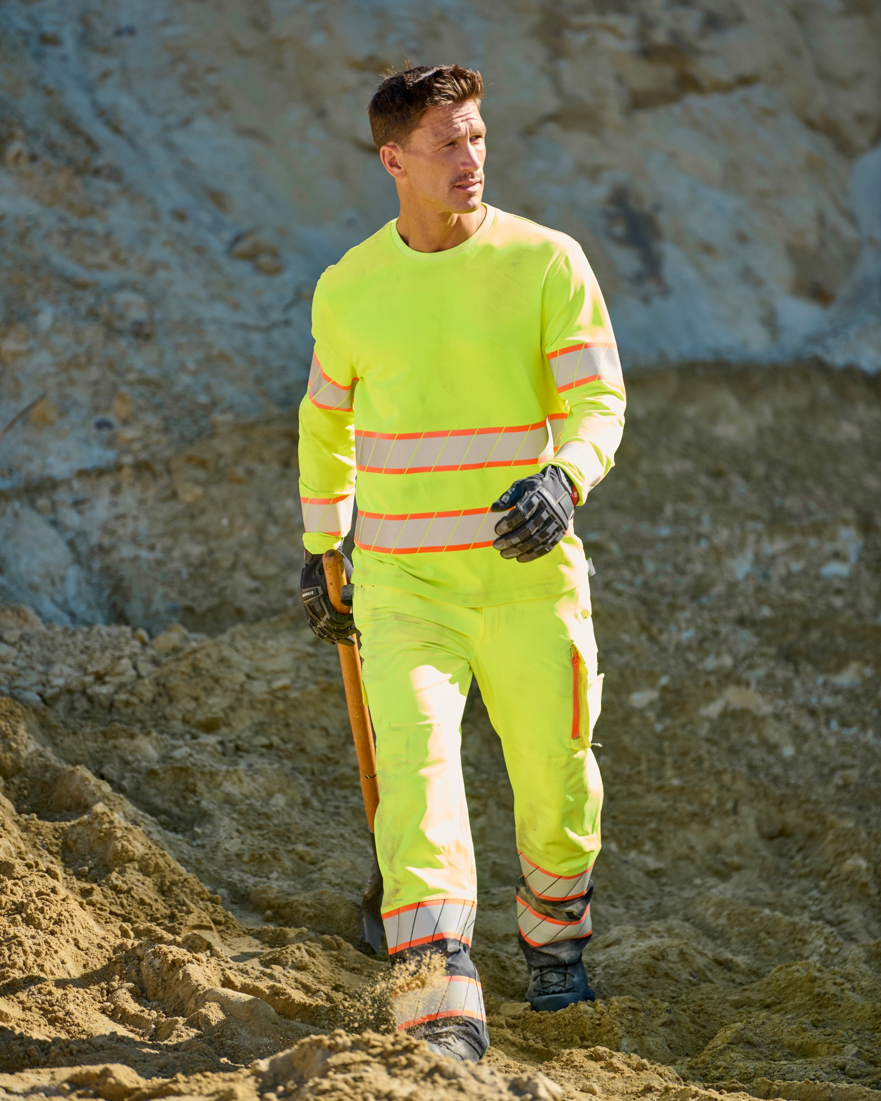 High Visibility Work Pants in neon yellow/black in use, showing fit and movement