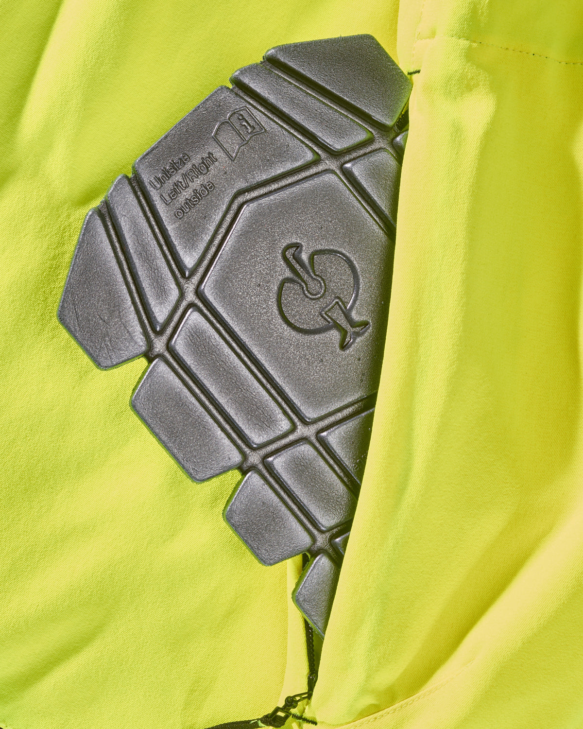 Close-up of knee pad pockets on High Visibility Work Pants in neon yellow/black