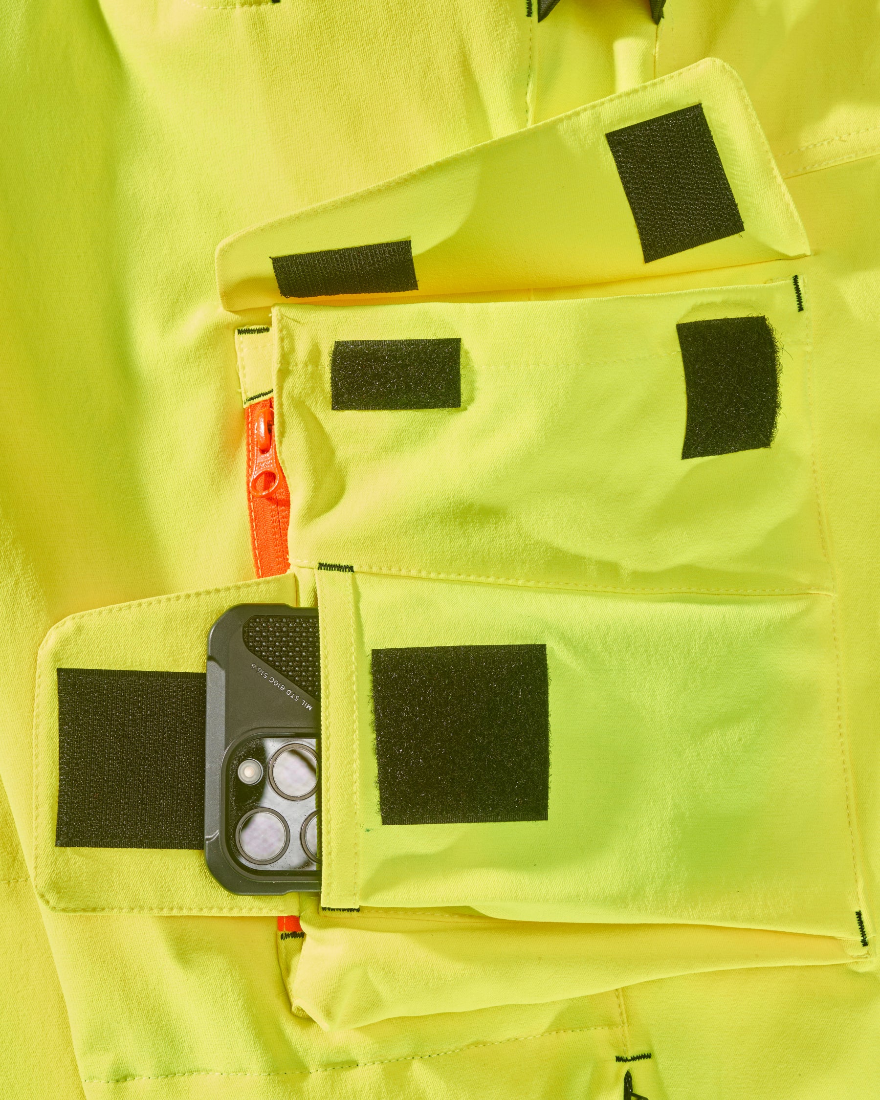 Close-up of reflective workwear details on High Visibility Work Pants in neon yellow/black