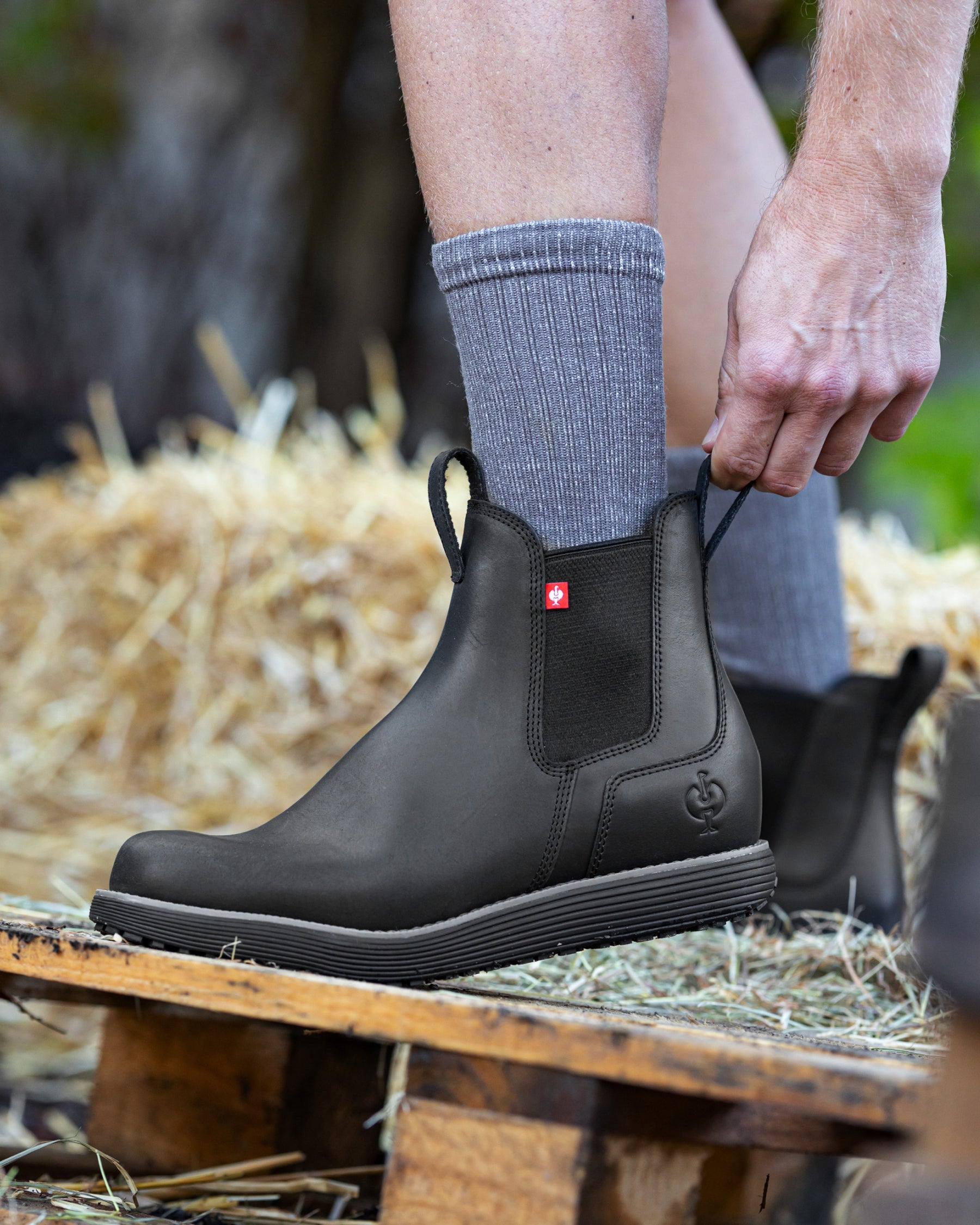 STRAUSS Amarillo 6-inch Soft Toe Chelsea Boot in Black shown on rough jobsite ground