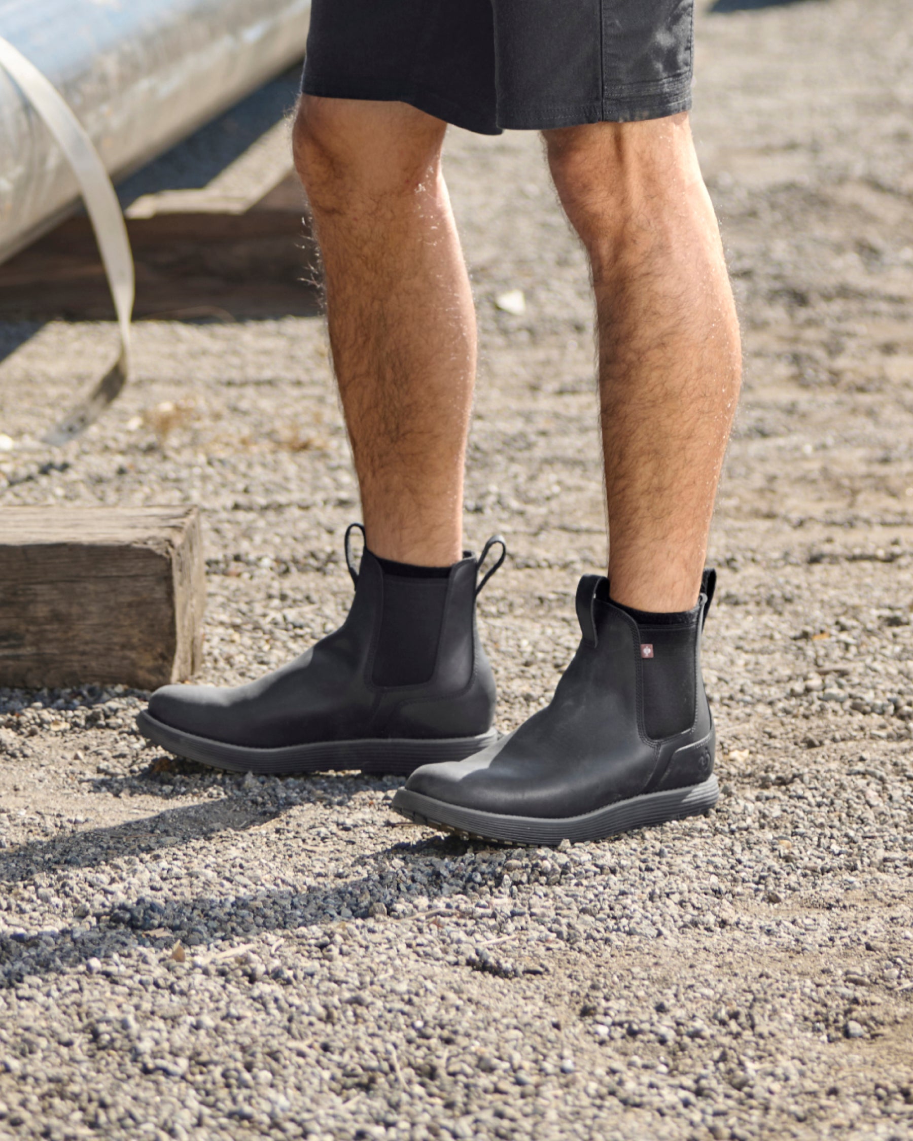 STRAUSS Amarillo 6-inch Soft Toe Chelsea Boot in Black worn in an outdoor work setting