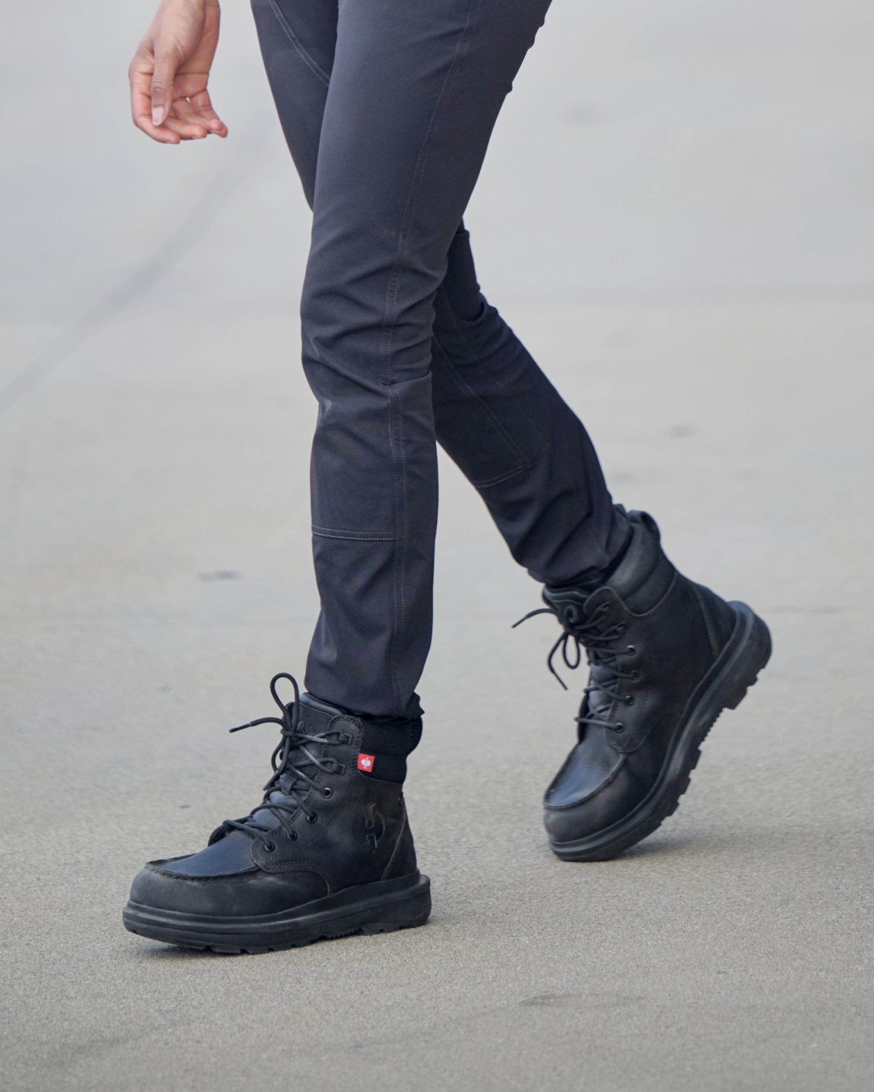STRAUSS Ridgewood 6-inch Soft Toe Boot in Black shown on rough jobsite ground