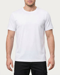 A model wears the STRAUSS Cotton Stretch T-Shirt in white with tan work pants and work boots in a studio product scene