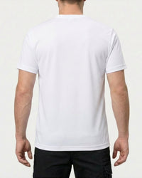 A model wears the STRAUSS Cotton Stretch T-Shirt in white with tan work pants and work boots, showing the shirt fit