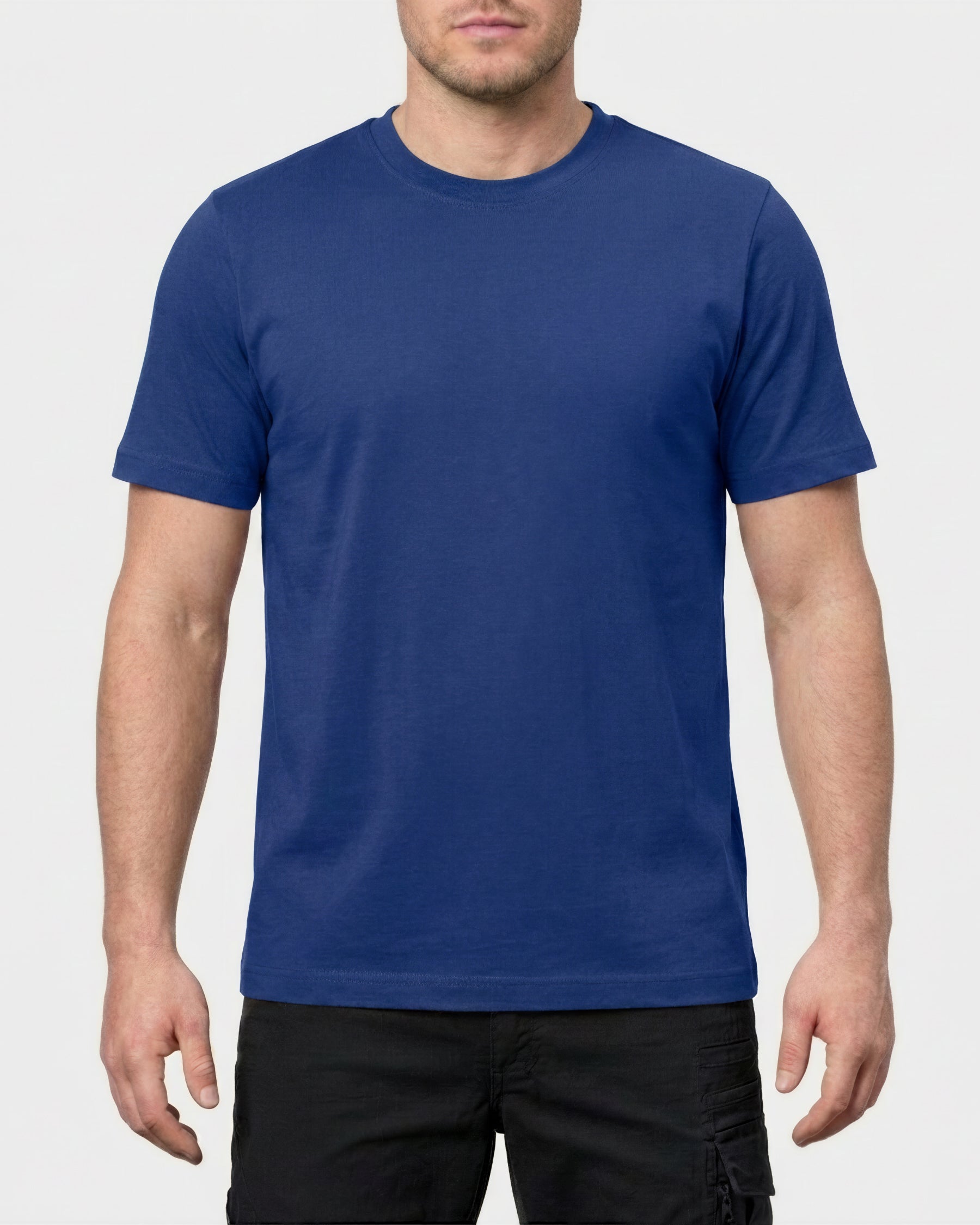A model wears the STRAUSS Cotton Stretch T-Shirt in royal blue with tan work pants and work boots in a studio product scene