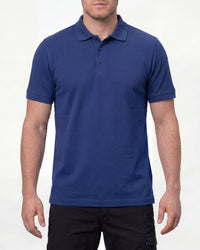 A model wears the STRAUSS Cotton Stretch Polo Shirt in royal blue with tan work pants and work boots in a studio product scene