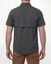 A model wears the STRAUSS e.s.taktik Stretch Ripstop Short Sleeve Work Shirt in carbon gray open over a T-shirt with work pants and work boots, showing the shirt fit