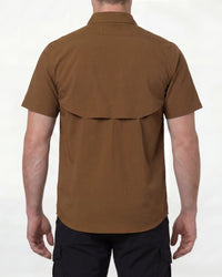A model wears the STRAUSS e.s.taktik Stretch Ripstop Short Sleeve Work Shirt in desert brown open over a T-shirt with work pants and work boots, showing the shirt fit