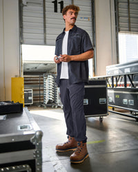 A worker wears the STRAUSS e.s.taktik Stretch Ripstop Short Sleeve Work Shirt in nero blue