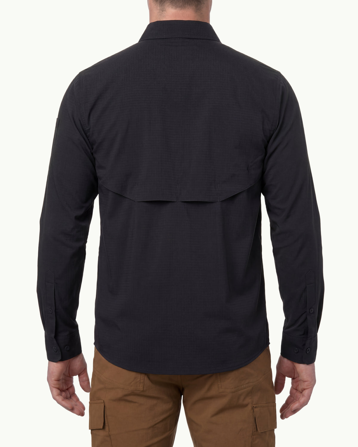 A model wears the STRAUSS e.s.taktik Stretch Ripstop Long Sleeve Work Shirt in black open over a T-shirt with work pants and work boots, showing the shirt fit