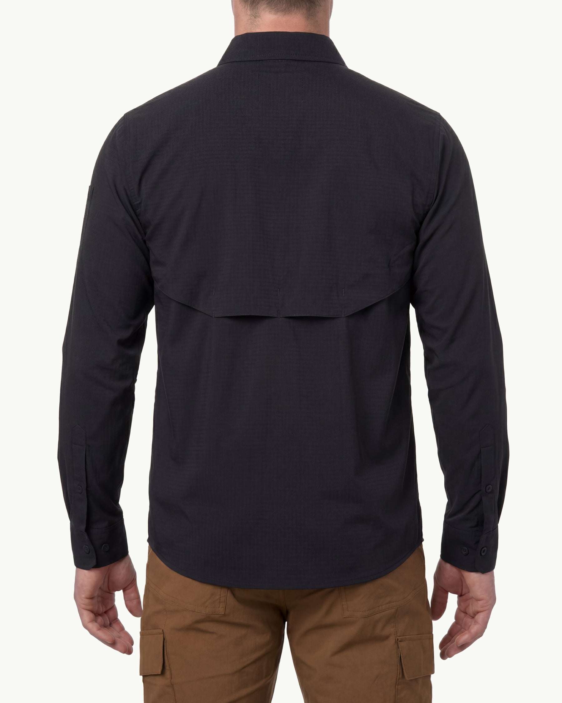 A model wears the STRAUSS e.s.taktik Stretch Ripstop Long Sleeve Work Shirt in black open over a T-shirt with work pants and work boots, showing the shirt fit