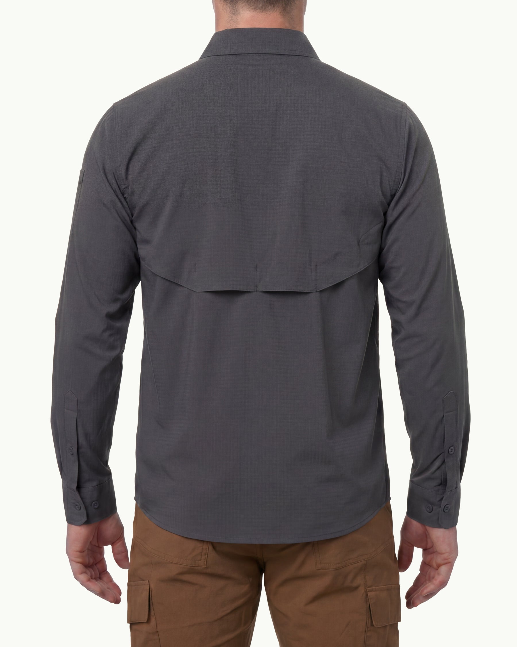 A model wears the STRAUSS e.s.taktik Stretch Ripstop Long Sleeve Work Shirt in carbon gray open over a T-shirt with work pants and work boots, showing the shirt fit