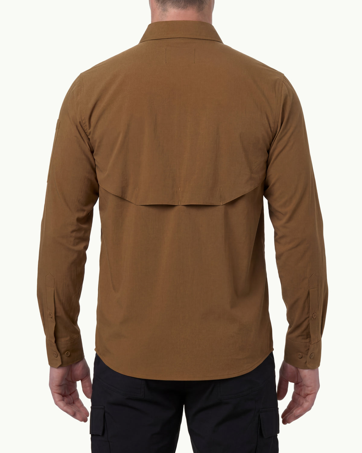 A model wears the STRAUSS e.s.taktik Stretch Ripstop Long Sleeve Work Shirt in desert brown open over a T-shirt with work pants and work boots, showing the shirt fit