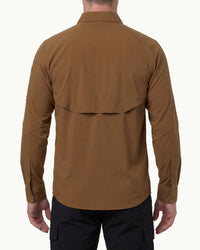 A model wears the STRAUSS e.s.taktik Stretch Ripstop Long Sleeve Work Shirt in desert brown open over a T-shirt with work pants and work boots, showing the shirt fit