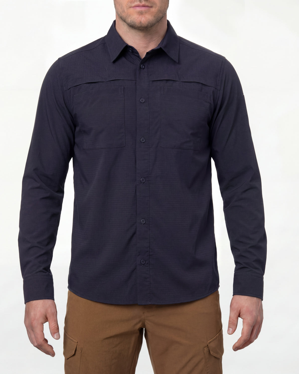 A model wears the STRAUSS e.s.taktik Stretch Ripstop Long Sleeve Work Shirt in nero blue open over a T-shirt with work pants and work boots in a studio product scene